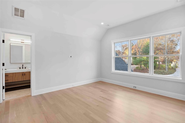 34 Old Main Rd, Quogue, NY 11959 - unfurnished bedroom featuring light wood-style floors, lofted ceiling, and ensuite bath