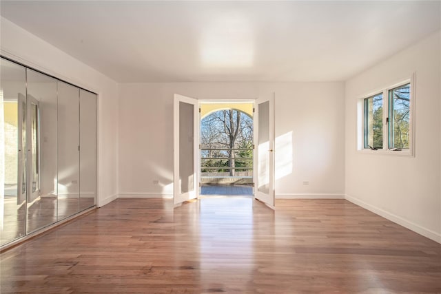 530 S Centre Island Rd, Centre Island, NY 11771 - empty room with healthy amount of natural light and wood finished floors