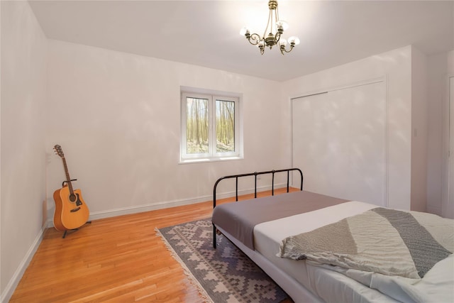 530 S Centre Island Rd, Centre Island, NY 11771 - bedroom featuring light wood-type flooring, a chandelier, and a closet