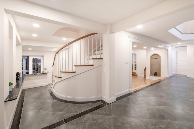 530 S Centre Island Rd, Centre Island, NY 11771 - foyer entrance featuring recessed lighting, stairs, marble tiled floors, a skylight, and arched walkways