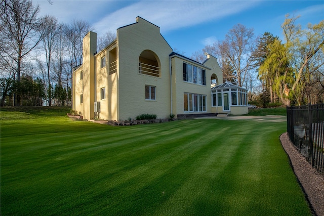 530 S Centre Island Rd, Centre Island, NY 11771 - rear view of property featuring a sunroom, a chimney, and stucco siding