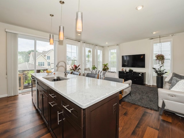 57 Lewis Rd, Hopewell Junction, NY 12533 - kitchen with open floor plan, dark wood-style flooring, hanging light fixtures, dark brown cabinets, and healthy amount of natural light