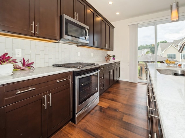 57 Lewis Rd, Hopewell Junction, NY 12533 - kitchen with stainless steel appliances, dark wood finished floors, recessed lighting, dark brown cabinets, and decorative backsplash