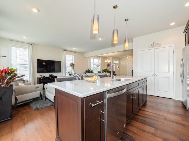 57 Lewis Rd, Hopewell Junction, NY 12533 - kitchen with stainless steel dishwasher, open floor plan, dark wood finished floors, pendant lighting, and light stone countertops