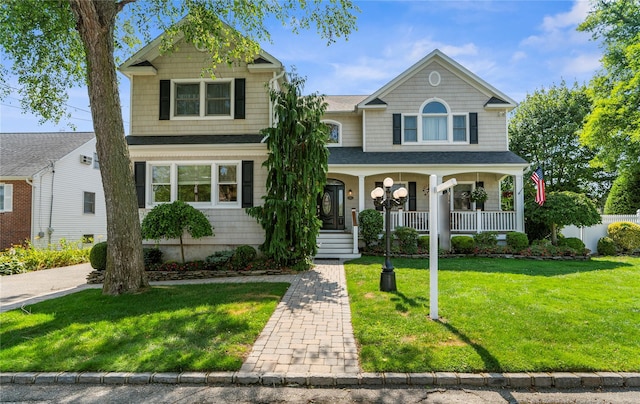 565 S 8th St, Lindenhurst, NY 11757 - view of front of home with covered porch and a front lawn