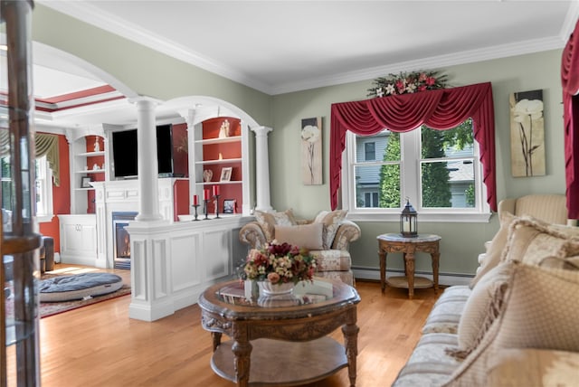 565 S 8th St, Lindenhurst, NY 11757 - living room featuring ornate columns, a baseboard heating unit, a fireplace, ornamental molding, and light wood-style flooring
