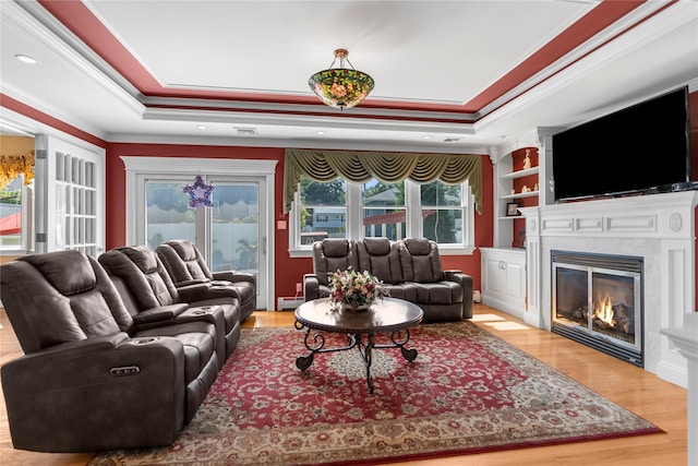 565 S 8th St, Lindenhurst, NY 11757 - living room featuring a tray ceiling, ornamental molding, wood finished floors, a glass covered fireplace, and a baseboard radiator