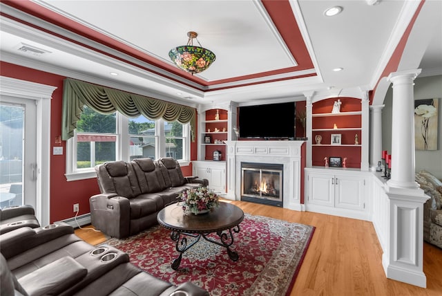 565 S 8th St, Lindenhurst, NY 11757 - living area with decorative columns, ornamental molding, a baseboard radiator, a glass covered fireplace, and light wood-type flooring