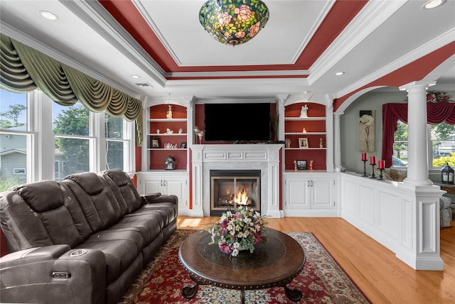 565 S 8th St, Lindenhurst, NY 11757 - living area featuring decorative columns, ornamental molding, light wood-type flooring, a fireplace, and a raised ceiling