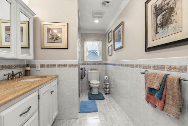 565 S 8th St, Lindenhurst, NY 11757 - bathroom featuring ornamental molding, vanity, tile walls, wainscoting, and tile patterned flooring