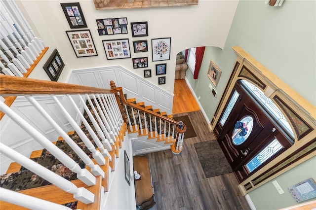 565 S 8th St, Lindenhurst, NY 11757 - stairs featuring wood finished floors and arched walkways