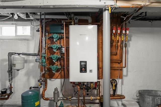 565 S 8th St, Lindenhurst, NY 11757 - utility room featuring tankless water heater