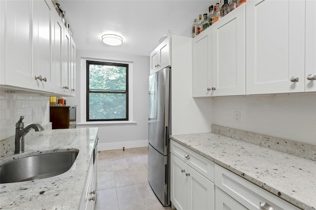 37 Central Ave Unit 2G, Hartsdale, NY 10530 - kitchen featuring freestanding refrigerator, decorative backsplash, white cabinetry, and light tile patterned flooring