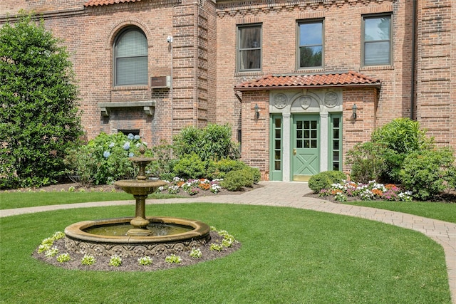 37 Central Ave Unit 2G, Hartsdale, NY 10530 - view of front facade featuring a front lawn, a tile roof, and brick siding
