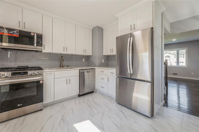 34 Klein Ave, West Nyack, NY 10994 - kitchen featuring stainless steel appliances, light countertops, tasteful backsplash, and white cabinetry