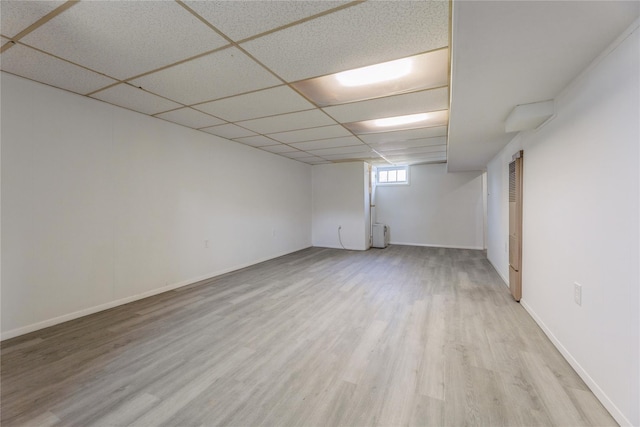 34 Klein Ave, West Nyack, NY 10994 - basement with light wood-style floors, a heating unit, and a paneled ceiling