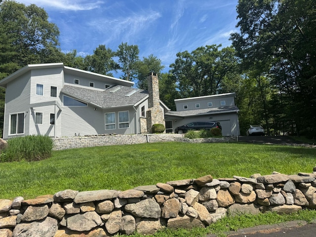 3 Burning Brush Ct, Pomona, NY 10970 - rear view of house with a chimney and a yard