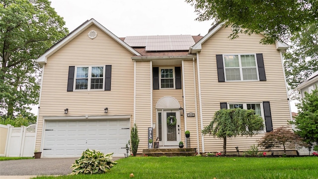 948 Orlando Ave, West Hempstead, NY 11552 - view of front of property with an attached garage, roof mounted solar panels, driveway, and a shingled roof