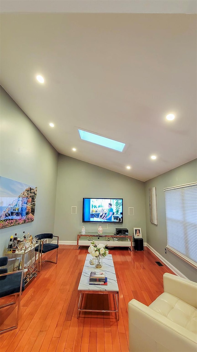 948 Orlando Ave, West Hempstead, NY 11552 - living room with a skylight, light wood-type flooring, vaulted ceiling, and recessed lighting