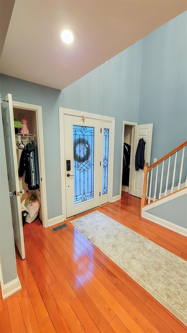 948 Orlando Ave, West Hempstead, NY 11552 - entrance foyer with light wood-style floors, stairway, and high vaulted ceiling