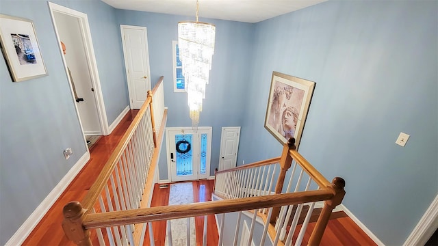948 Orlando Ave, West Hempstead, NY 11552 - stairway with a chandelier and wood finished floors