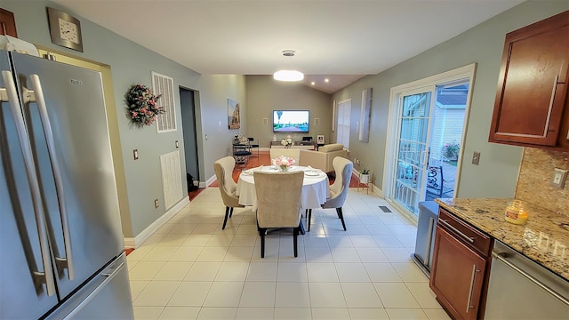 948 Orlando Ave, West Hempstead, NY 11552 - dining area with plenty of natural light, vaulted ceiling, and light tile patterned flooring