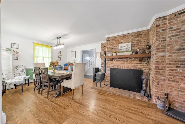 48 Eastview Rd, Highland Mills, NY 10930 - dining room with wood finished floors, crown molding, and a brick fireplace