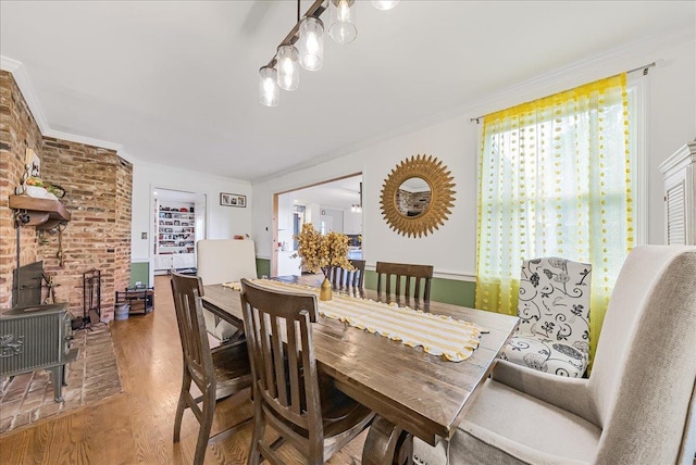 48 Eastview Rd, Highland Mills, NY 10930 - dining space featuring wood finished floors, crown molding, and a wood stove