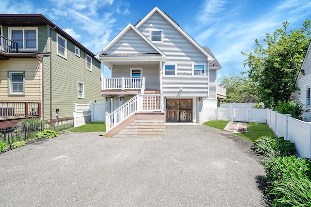43 E Jackson Ave, Babylon, NY 11702 - view of front of home featuring asphalt driveway, a gate, and stairway