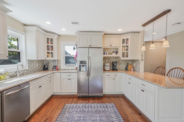 43 E Jackson Ave, Babylon, NY 11702 - kitchen with appliances with stainless steel finishes, a peninsula, decorative backsplash, dark wood-type flooring, and glass insert cabinets