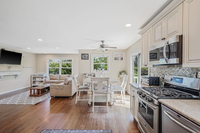 43 E Jackson Ave, Babylon, NY 11702 - kitchen with stainless steel appliances, cream cabinetry, dark wood finished floors, backsplash, and ceiling fan