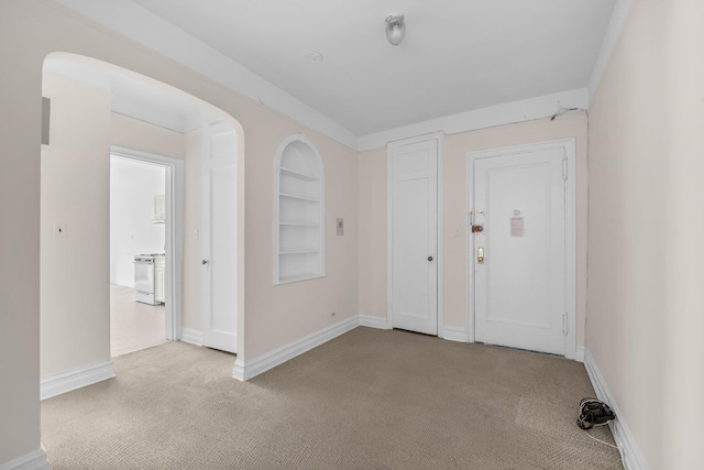 111-15 75th Ave Unit 4K, Forest Hills, NY 11375 - carpeted entryway with baseboards and arched walkways