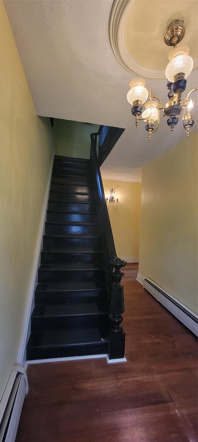 5-7 Myrtle Ave, Pine Plains, NY 12567 - stairway with a baseboard heating unit, wood finished floors, and a chandelier