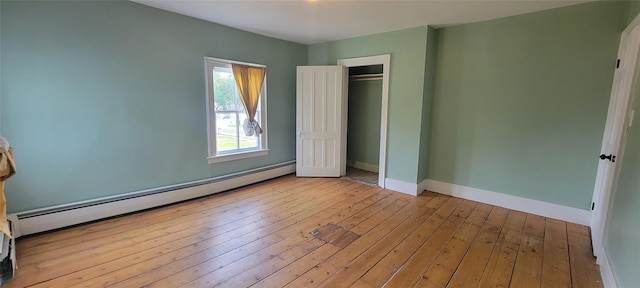 5-7 Myrtle Ave, Pine Plains, NY 12567 - unfurnished bedroom featuring a baseboard radiator, wood-type flooring, and a closet