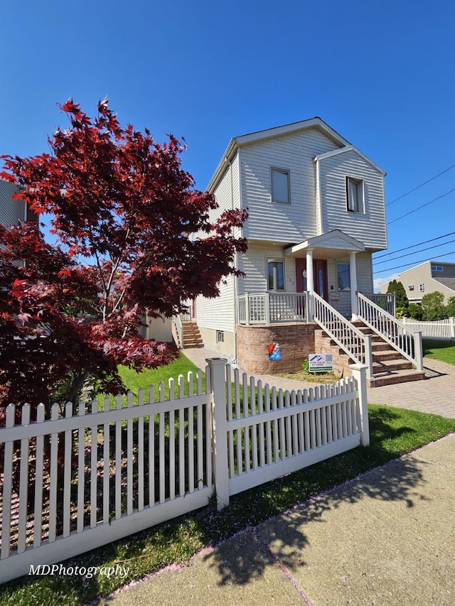 385 Oceanside Pkwy, Oceanside, NY 11572 - view of front facade with a fenced front yard