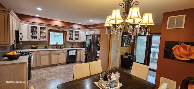 385 Oceanside Pkwy, Oceanside, NY 11572 - kitchen featuring a chandelier, black appliances, glass insert cabinets, light countertops, and tasteful backsplash
