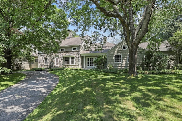 383 Pine Brook Rd, Bedford, NY 10506 - view of front of property with stone siding, french doors, a front lawn, and a chimney