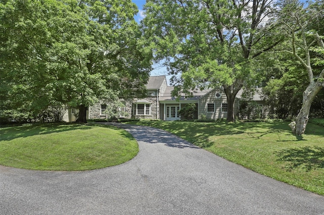 383 Pine Brook Rd, Bedford, NY 10506 - view of front of property with french doors, stone siding, a front yard, and asphalt driveway