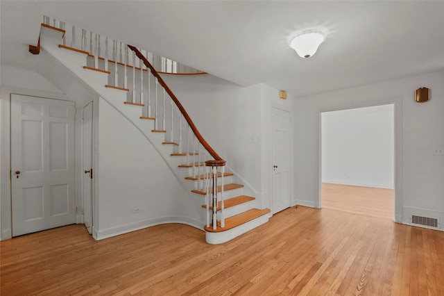 383 Pine Brook Rd, Bedford, NY 10506 - stairs featuring wood-type flooring and baseboards