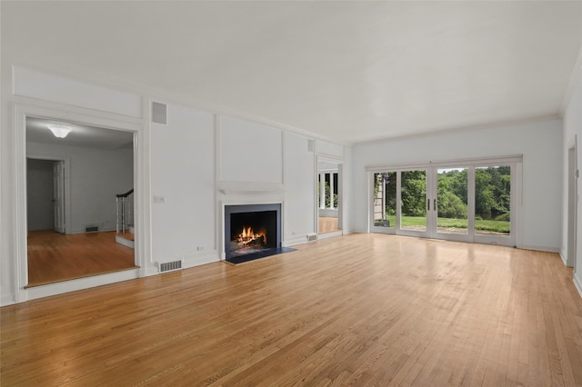 383 Pine Brook Rd, Bedford, NY 10506 - unfurnished living room featuring light wood finished floors, a lit fireplace, and crown molding