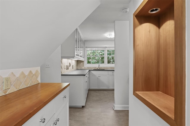 383 Pine Brook Rd, Bedford, NY 10506 - kitchen with glass insert cabinets, white cabinets, light floors, and tasteful backsplash