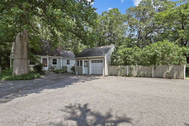 383 Pine Brook Rd, Bedford, NY 10506 - view of front of property featuring an outdoor structure, driveway, a garage, and a chimney