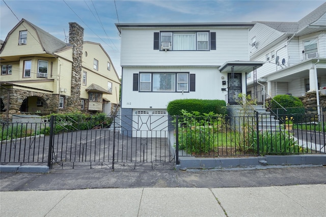 112 N Columbus Ave, Mount Vernon, NY 10553 - view of front of home with an attached garage, a fenced front yard, and concrete driveway