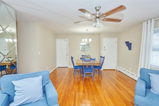 112 N Columbus Ave, Mount Vernon, NY 10553 - dining space with a baseboard heating unit, light wood-type flooring, a chandelier, and a ceiling fan