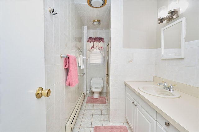 112 N Columbus Ave, Mount Vernon, NY 10553 - full bathroom featuring a baseboard heating unit, tile walls, a tile shower, vanity, and tile patterned floors