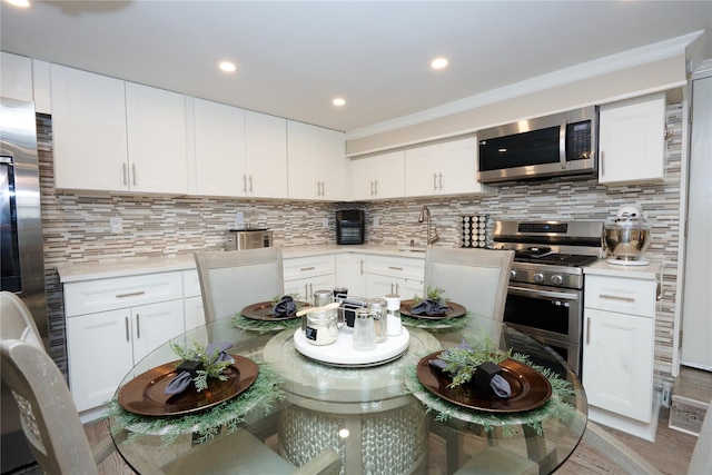 112 N Columbus Ave, Mount Vernon, NY 10553 - kitchen with stainless steel appliances, light countertops, backsplash, white cabinets, and recessed lighting