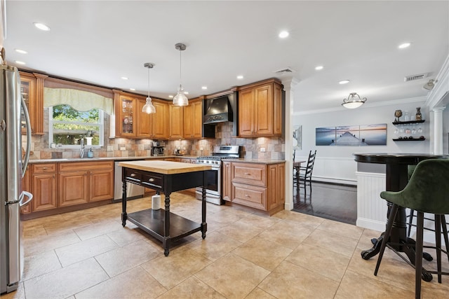 40 Spray Ct, Bayport, NY 11705 - kitchen with appliances with stainless steel finishes, crown molding, custom exhaust hood, tasteful backsplash, and pendant lighting