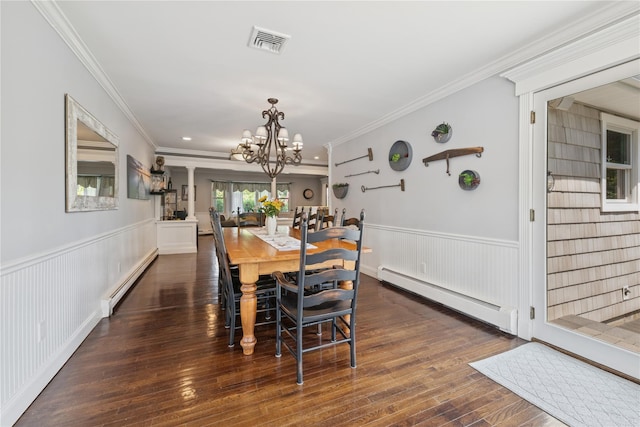 40 Spray Ct, Bayport, NY 11705 - dining area with a baseboard heating unit, a chandelier, a wainscoted wall, wood finished floors, and crown molding
