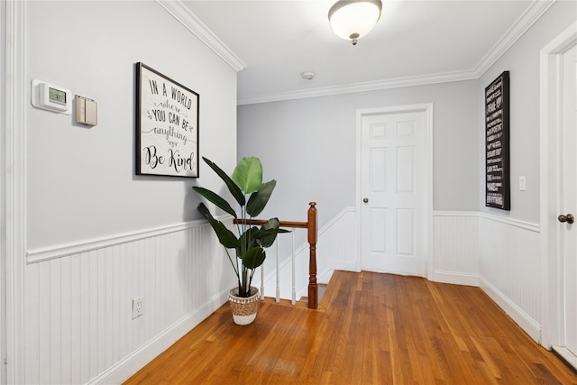 40 Spray Ct, Bayport, NY 11705 - hall featuring wood finished floors, a wainscoted wall, and ornamental molding