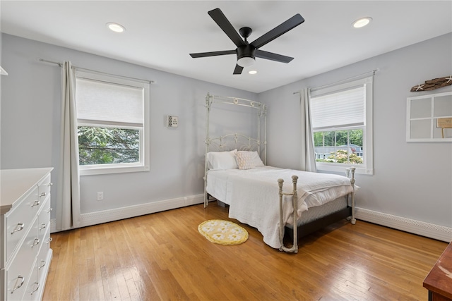 40 Spray Ct, Bayport, NY 11705 - bedroom featuring multiple windows, a baseboard radiator, light wood finished floors, recessed lighting, and a ceiling fan